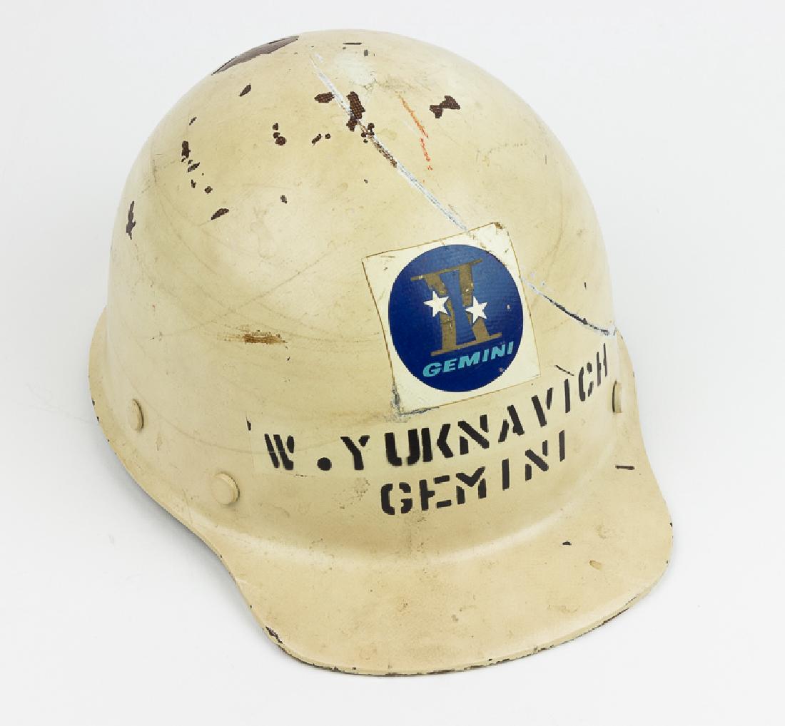 GEMINI II CREW HARD HAT: GEMINI II CREW HARD HAT A great NASA relic, an official Gemini II hard hat used by a ground crew member at Cape Canaveral. The cream-colored hard hat bears a decal with the logo of the Gemini II missi