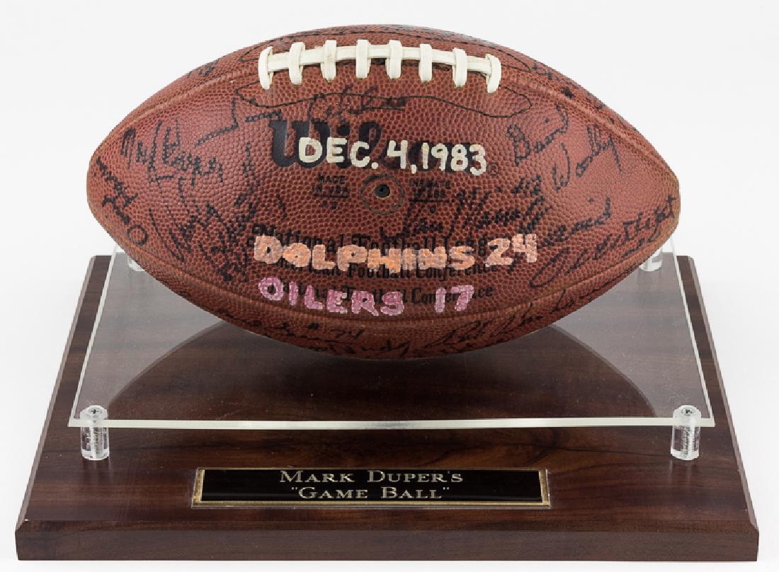 1983 DOLPHINS "GAME BALL" GIVEN TO MARK DUPER: 1983 DOLPHINS "GAME BALL" GIVEN TO MARK DUPER A great memento from the 1983 Miami Dolphins winning season, a team-signed ball with black ink signatures of 35 players, including DAN MARINO and coach DO