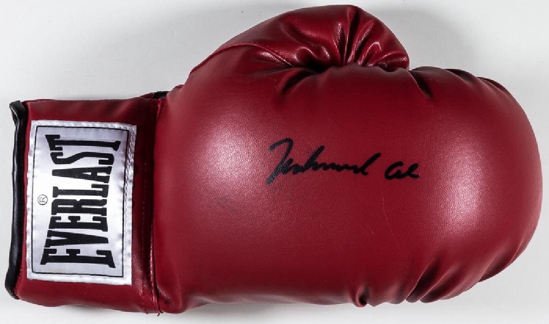 MUHAMMAD ALI SIGNED BOXING GLOVE: MUHAMMAD ALI SIGNED BOXING GLOVE (1942 - 2016) American boxer and three time heavyweight champion, stripped of his title for refusing military service. Right-handed red leather Everlast boxing glove,