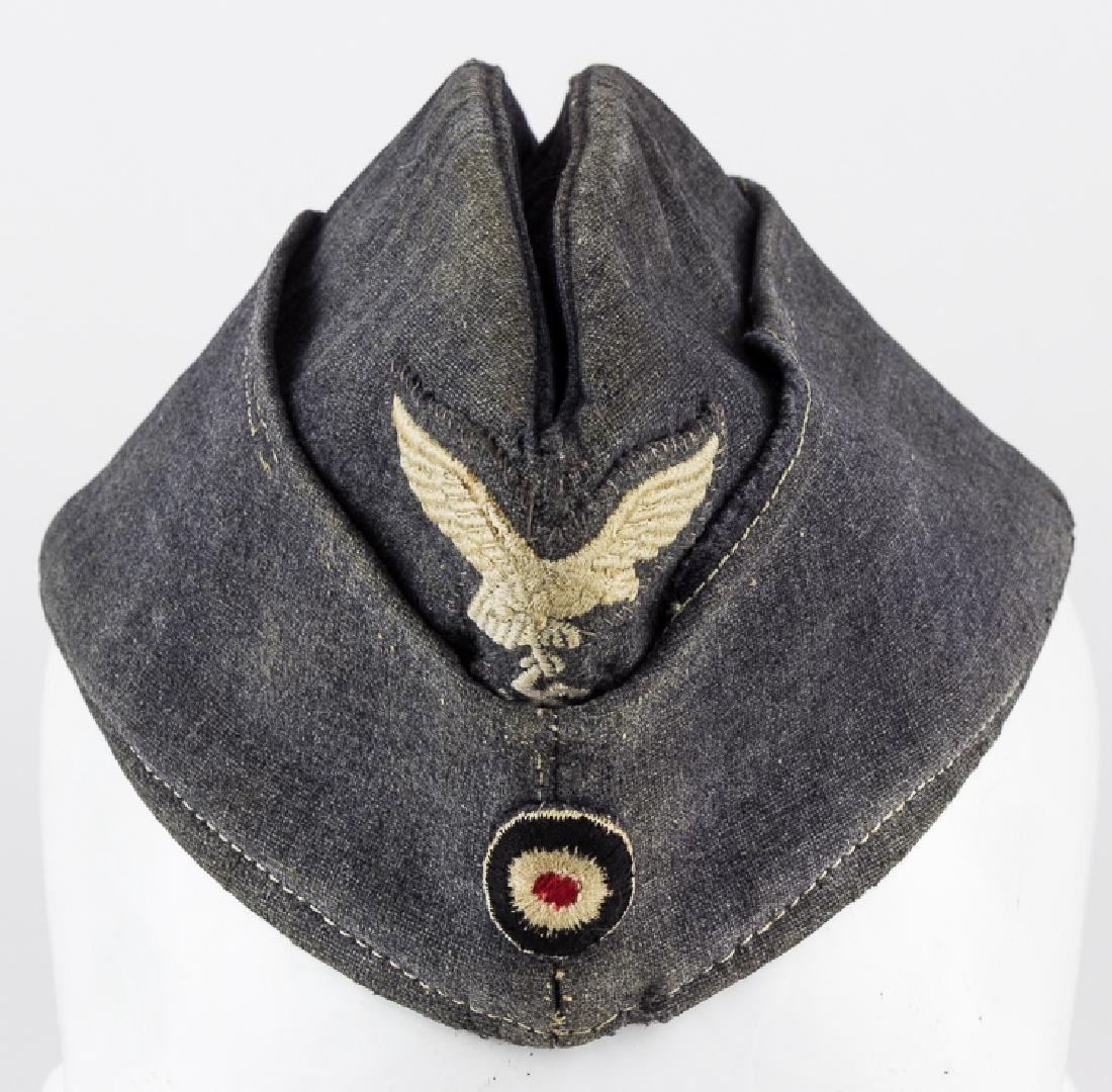 LUFWAFFE OVERSEAS SIDE CAP: LUFWAFFE OVERSEAS SIDE CAP Luftwaffe "fliegermÃ¼tze" overseas cap with machine embroidered second pattern eagle and tricolor cockade both hand stitched in position. The interior of the cap is fully 