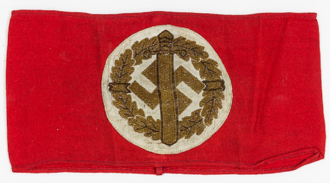 S.A. SPORTS ARMBAND: S.A. SPORTS ARMBAND S.A. Sports armband worn by participants in S.A. sports competitions, 16 1/2" x 4" cotton with embroidered sword, oak leaves and swastika, joined at rear. With paper RZM tag witin.