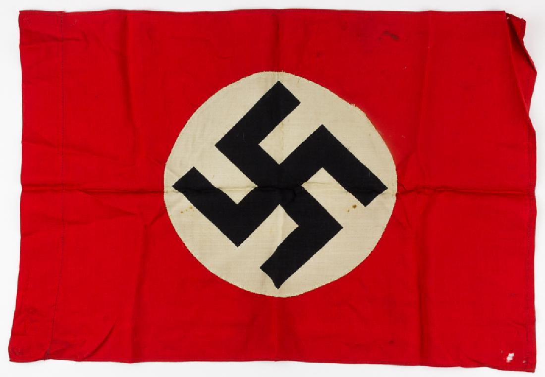 N.S.D.A.P. FLAG: N.S.D.A.P. FLAG Small Third Reich-era flag, 24 1/2" x 16", constructed of red cotton bunting with a white disk bearing a clamp-dyed swastika sewn to each side. One end is folded over and sewn to form 