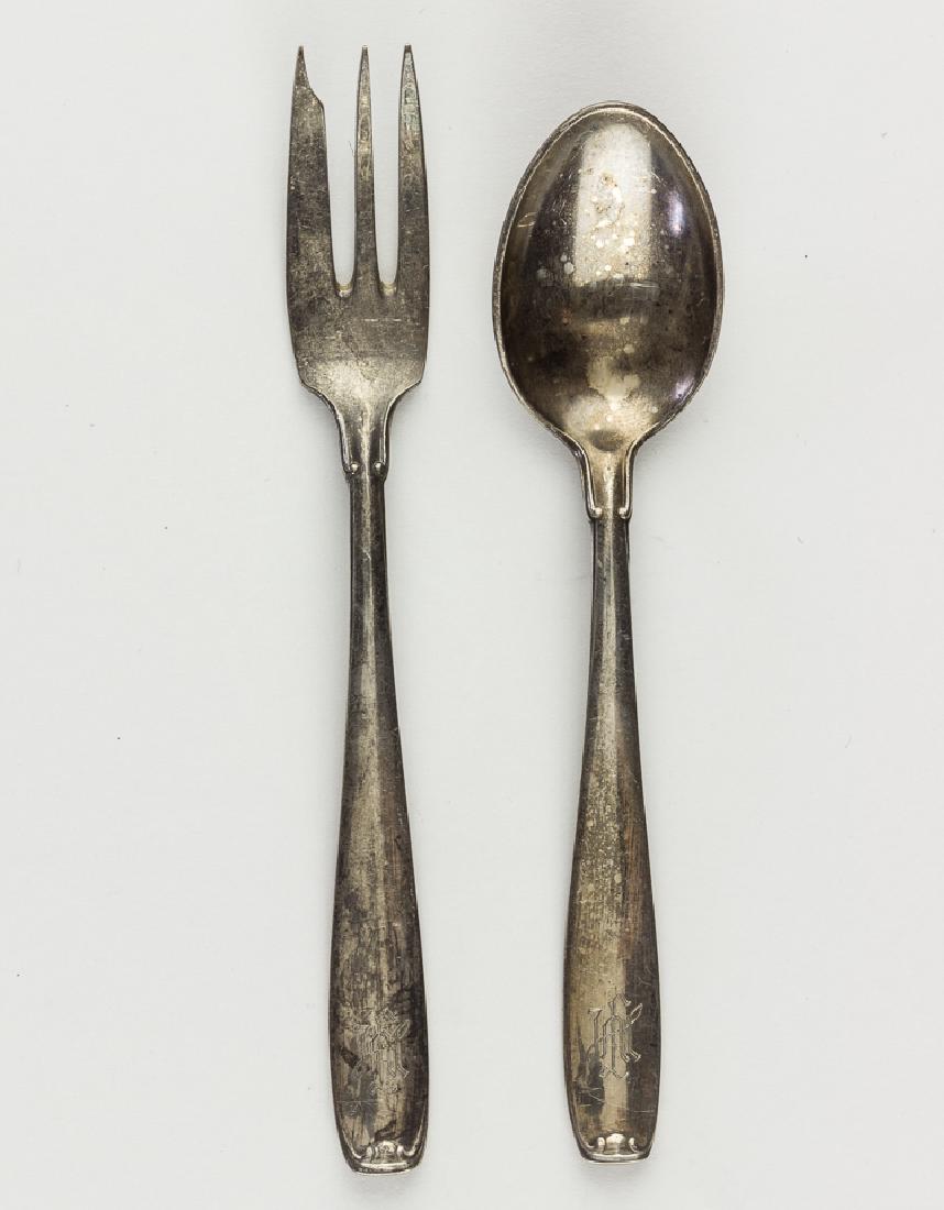 LEIBSTANDARTE ADOLF HITLER TABLEWARE (2): LEIBSTANDARTE ADOLF HITLER TABLEWARE (2) Two pieces of Leibstandarte Adolf Hitler Division matching silver-plated tableware, includes dessert fork (5" long) and demitasse spoon (5 1/2" long), each bea