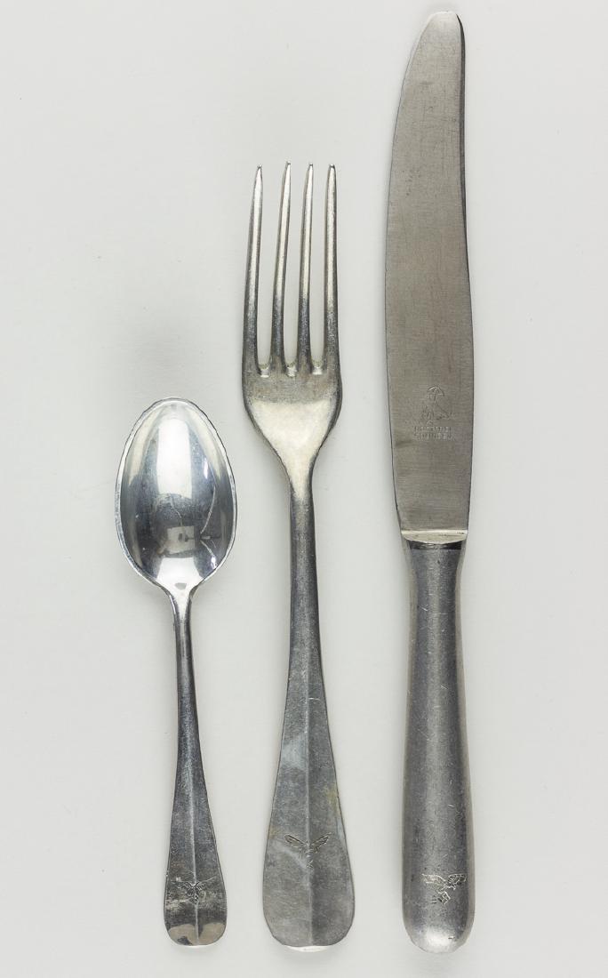 LUFTWAFFE TABLEWARE: LUFTWAFFE TABLEWARE Three pieves of Luftwaffe tableware, a knife, fork and teaspooon, each made of aluminum and marked with the emblem of that service. Condition varies.