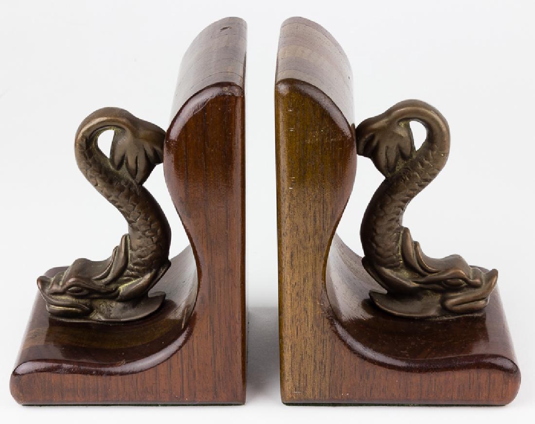 SUBMARINER "DOLPHIN" BOOKENDS: SUBMARINER "DOLPHIN" BOOKENDS Nice pair of submariner "dolphin" themed bookends, probably theater-made, each 7" tall, 4" wide with a cast bronze dolphin symbolic of the submarine service attached two 