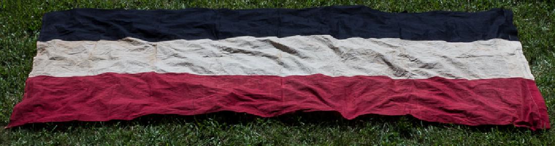 IMPERIAL GERMAN HANGING FLAG: IMPERIAL GERMAN HANGING FLAG Large Imperial German national flag, 48" x 117", constructed of three sewn-together bands of red, white, and black cotton bunting. One end is folded over and sewn to form 