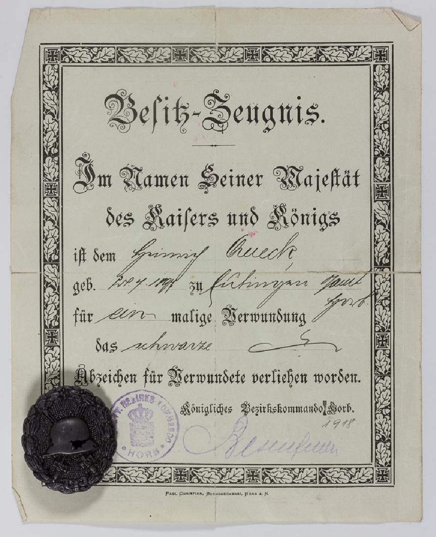 WORLD WAR I WOUND BADGE IN BLACK WITH CITATION: WORLD WAR I WOUND BADGE IN BLACK WITH CITATION German Wound Badge in Black, 1 1/2" x 1 3/4", 1918 version, with accompanying award citation, 1p. 8vo., giving the recipient's name and birth date, signe