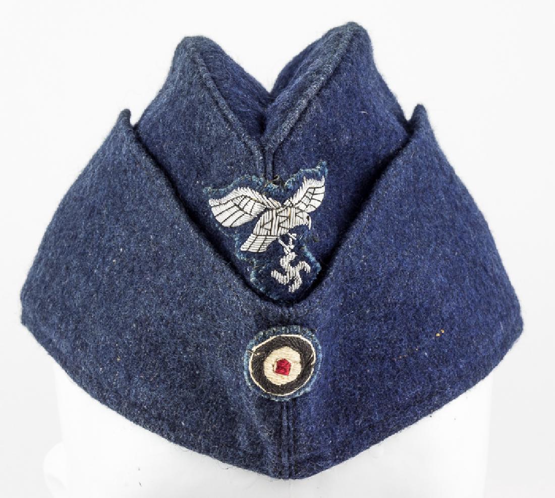 LUFTWAFFE EM/NCO OVERSEAS CAP: LUFTWAFFE EM/NCO OVERSEAS CAP Luftwaffe EM/NCO overseas side cap, dark blue wool with a sewn-on wire wire insignia (most often seen on officer's caps) attached at front, above a cloth national cockade
