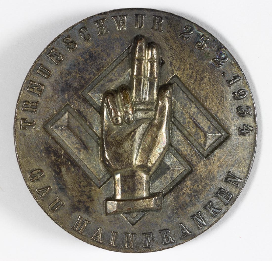 MAINFRANKEN LOYALTY TO HITLER OATH BADGE, 1934: MAINFRANKEN LOYALTY TO HITLER OATH BADGE, 1934 Treueschwur Gau Mainfranken Badge 1934, issued to commemorate the oath taken by Nazi leaders and sub-leaders who swore their allegiances to Hitler in a c