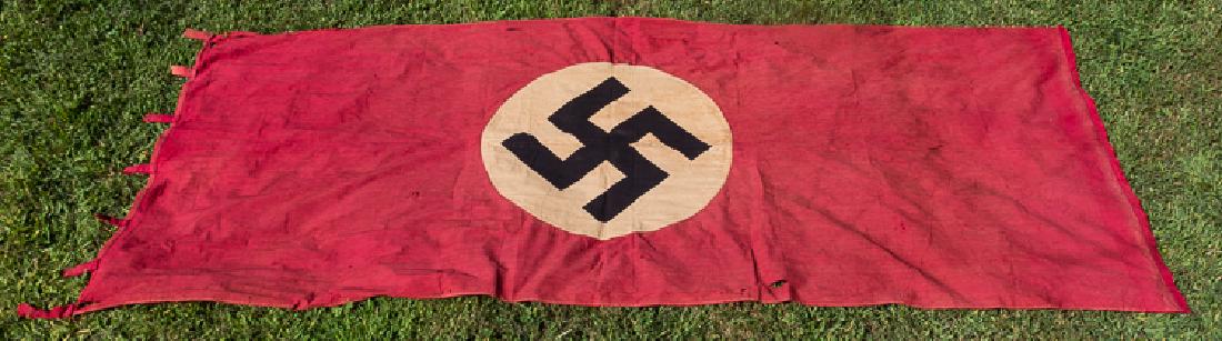NSDAP HANGING BANNER: NSDAP HANGING BANNER Original NSDAP banner, 104 1/2" x 46 1/2", of red cotton bunting or rayon construction, with a separate white disk bearing a clamp-dyed mobile swastika sewn at the center. The hoi