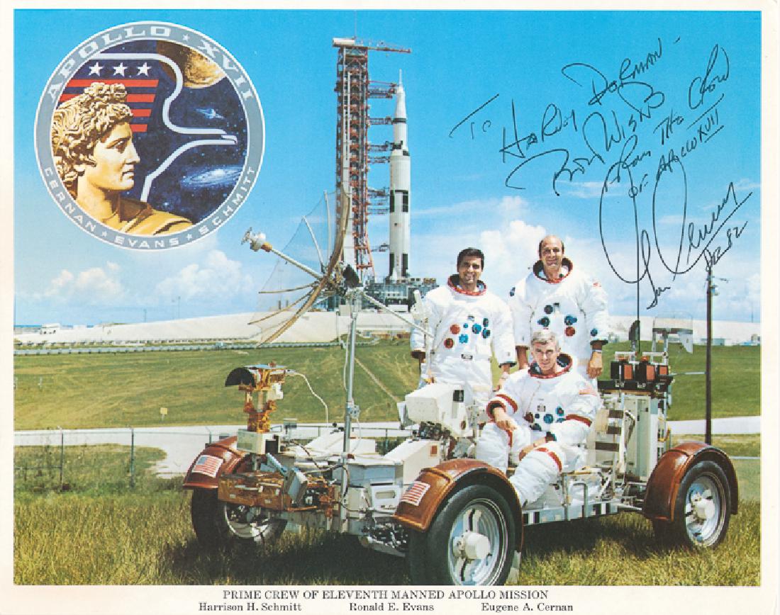 GENE CERNAN: GENE CERNAN (b. 1934) American astronaut, flew on Gemini IX, Apollo 10 and commanded Apollo 17, becoming the last man to walk on the moon. I.S.P. 8" x 10" color shows the crew of Apollo 17 on a mock-u