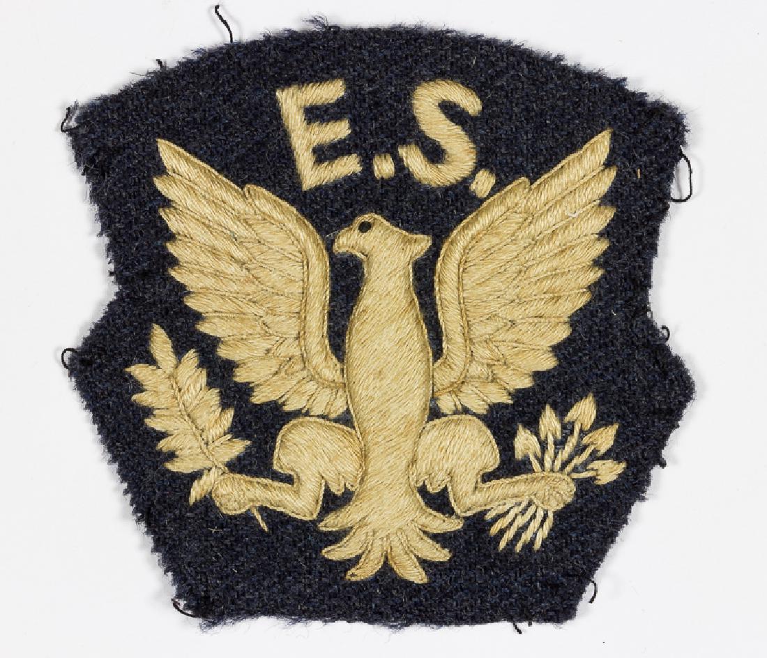 "EAGLE SQUADRON" SHOULDER PATCH: "EAGLE SQUADRON" SHOULDER PATCH Rare Royal Air Force Eagle Squadron shoulder patch, white embroidery upon a navy blue backing and black cloth backing, with remnants of the stitching which held it to t