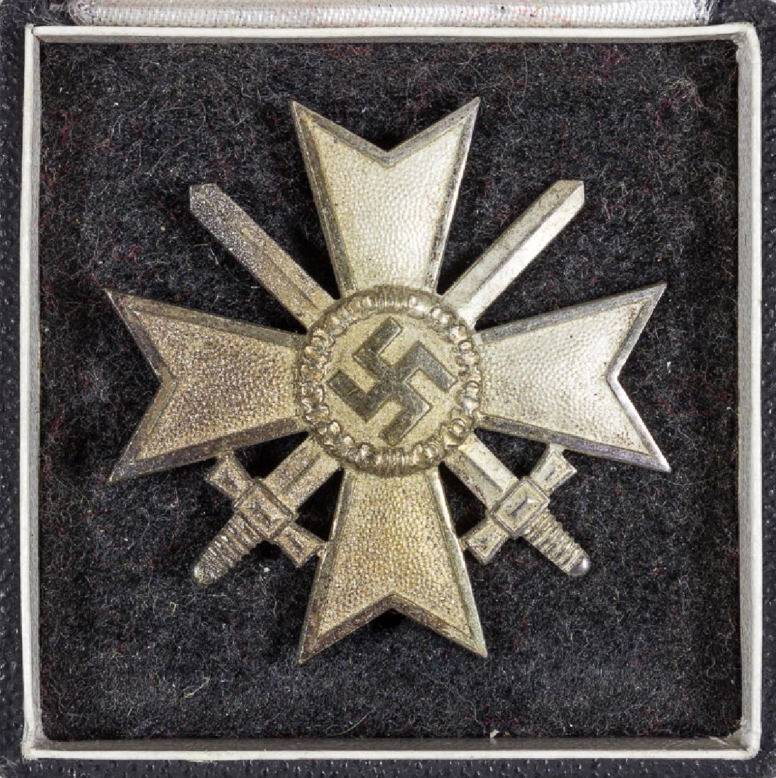 CASED WAR MERIT CROSS WITH SWORDS, FIRST CLASS, BY: CASED WAR MERIT CROSS WITH SWORDS, FIRST CLASS, BY DESCHLER A cased War Merit Cross, First Class, by Deschler, the reverse with a vertical banjo style pinback and a functional hinge/catch assembly. Th