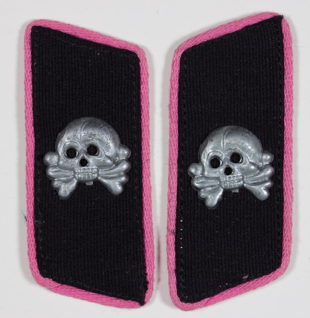 PANZER EM/NCO COLLAR TABS: PANZER EM/NCO COLLAR TABS Panzer enlisted man or NCO's collar tabs, each 3" long, very lightly ribbed black tricot base with pink piping, an aluminum "totenkopf" affixed to each with three aluminum ta
