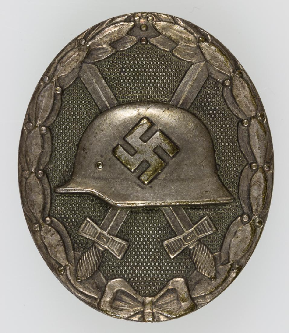 WOUND BADGE IN SILVER, CASED: WOUND BADGE IN SILVER, CASED Cased Wound Badge in Silver, marked "30" on reverse attributing manufacture to the Hauptmunzamt of Vienna firm. Fine condition, in fitted, quite worn case bearing the firm