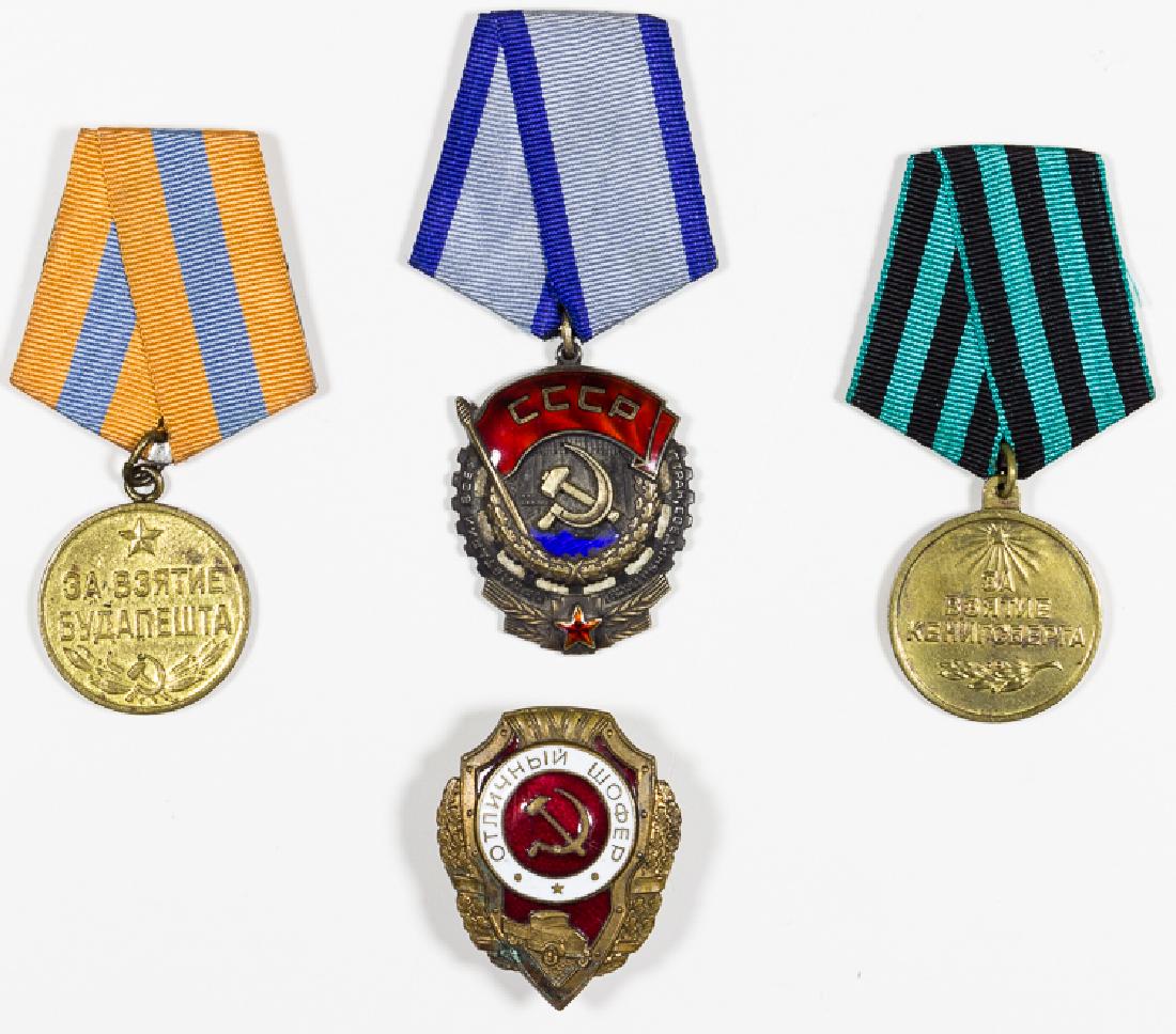WWII RUSSIAN BADGES: WWII RUSSIAN BADGES Lot of four Soviet WWII badges and medals. Includes a Capture of Budapest medal, an Order of the Red Banner of Labor medal, a Capture of Konigsberg medal, and an Excellent Driver b