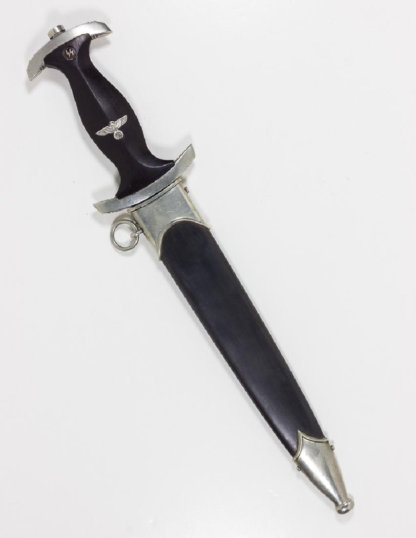 SS DAGGER WITH PRESENTATION ENGRAVING: SS DAGGER WITH PRESENTATION ENGRAVING A fine example of a 1940 SS dagger, 8 3/4" blade, 13 3/4" overall, completely original with matching scabbard. The ebony grip shows only use consistent with age,