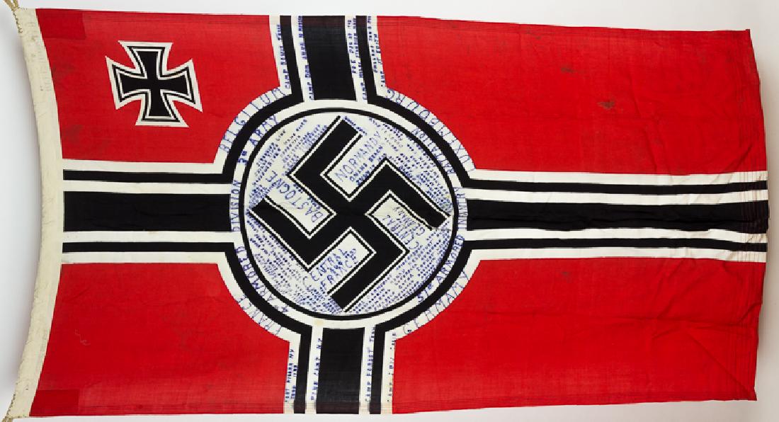 GERMAN FLAG CAPTURED BY THE 51ST ARMORED INFANTRY: GERMAN FLAG CAPTURED BY THE 51ST ARMORED INFANTRY BATTALION Reichskriegsflagge, 35" x 64" rayon, marked on the hoist by the maker (indistinguishable) at "Helmond, Holland", hemp loops sewn into the ho