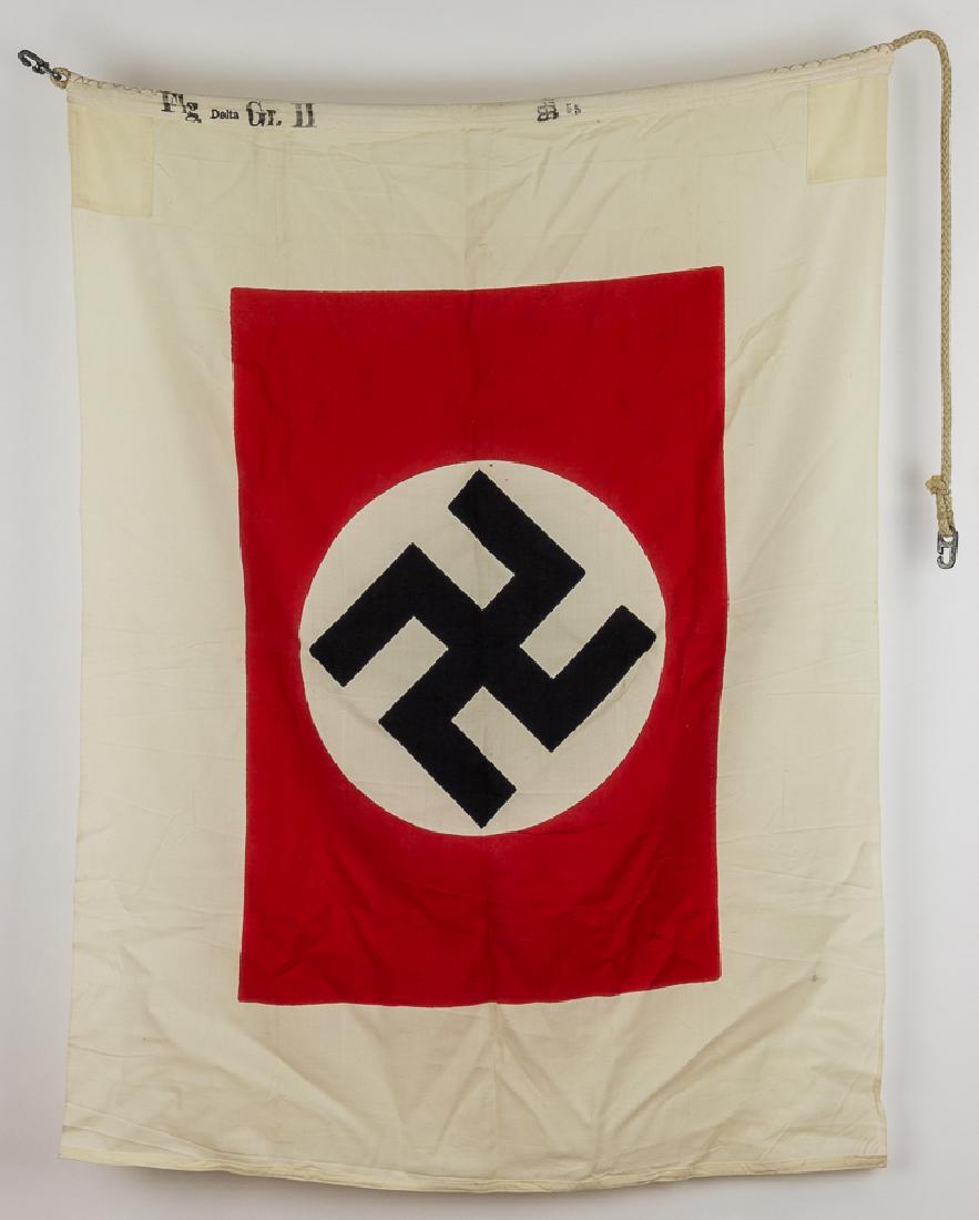 KRIEGSMARINE HARBOR PILOT FLAG: KRIEGSMARINE HARBOR PILOT FLAG Third Reich flag, 51" x 37", constructed of white cotton bunting, clamp-dyed with a mobile swastika on a white disk within a red field at center. The hoist corners are r