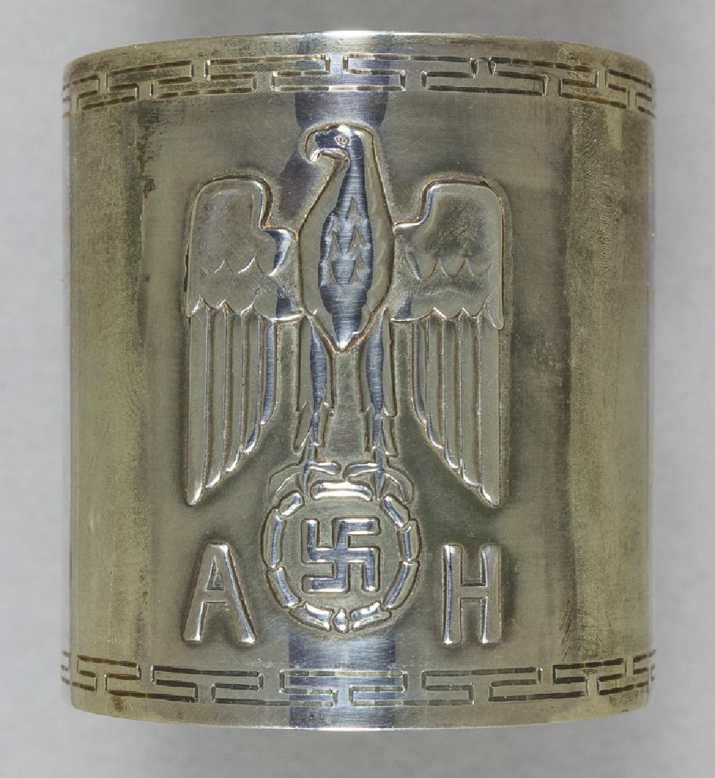 ADOLF HITLER FORMAL SERVICE NAPKIN RING: ADOLF HITLER FORMAL SERVICE NAPKIN RING Fine original formal silver napkin ring from one of Hitler's formal dinner services, 1 3/4" tall, 1 1/2" diameter, bearing a large Nazi eagle and swastika devic