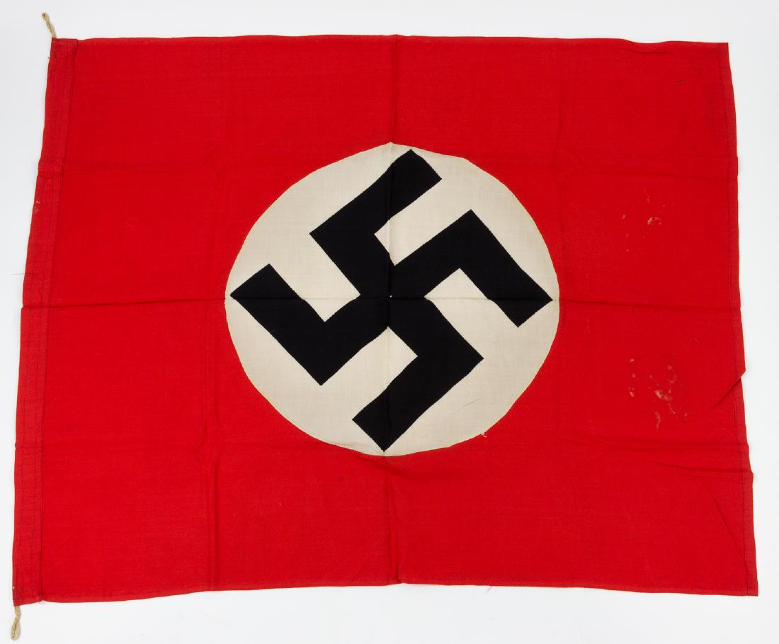 NSDAP FLAG: NSDAP FLAG Red cotton flag, 30 1/2" x 37 3/4", with a white disk sewn to each side, bearing a clamp-dyed black swastika at center. The hoist edge has been folded over and sewn, with hemp loops at each