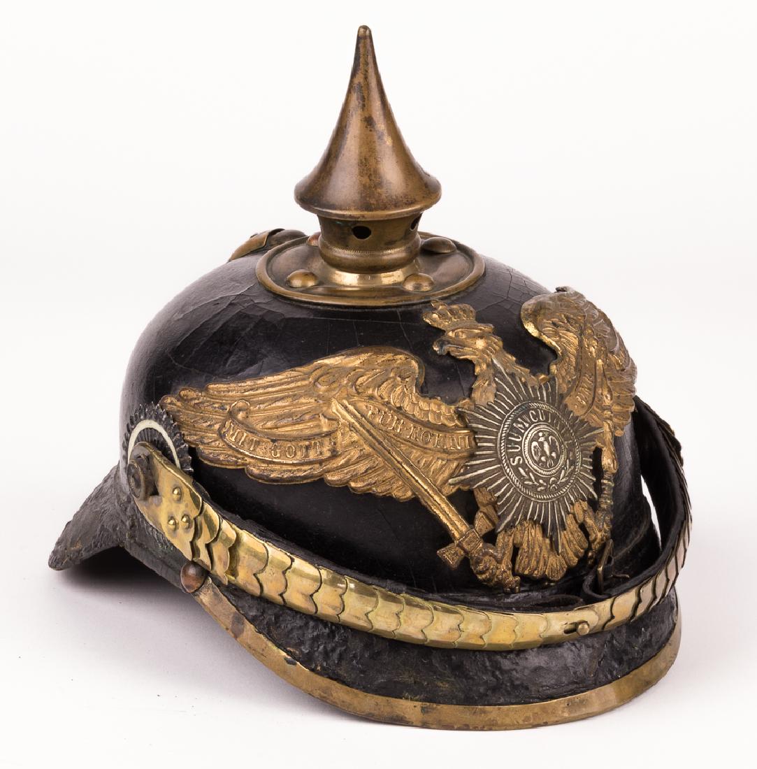 PRUSSIAN GUARD INFANTRY PICKELHAUBE HELMET: World War I-era German "Pickelhaube", constructed of lacquered black leather, with a brass circular plate at the crown bearing four rivets, topped with a 3 1/2" brass spike. The front bears a brass "w