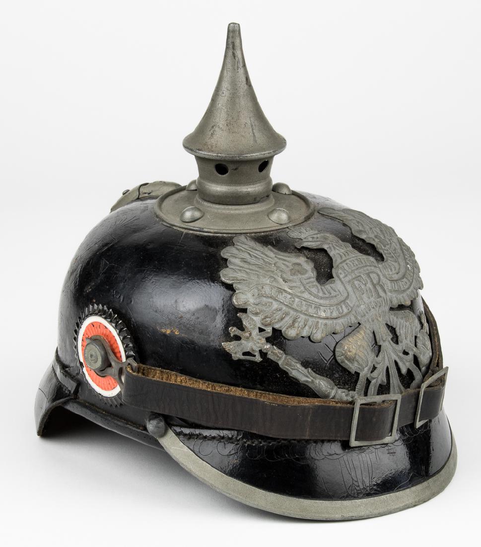 UNISSUED PRUSSIAN PICKELHAUBE HELMET: World War I-era German "Pickelhaube", constructed of lacquered black leather, with a grey metal circular plate at the crown bearing four rivets, topped with a removable 4 1/2" grey metal spike. The fr