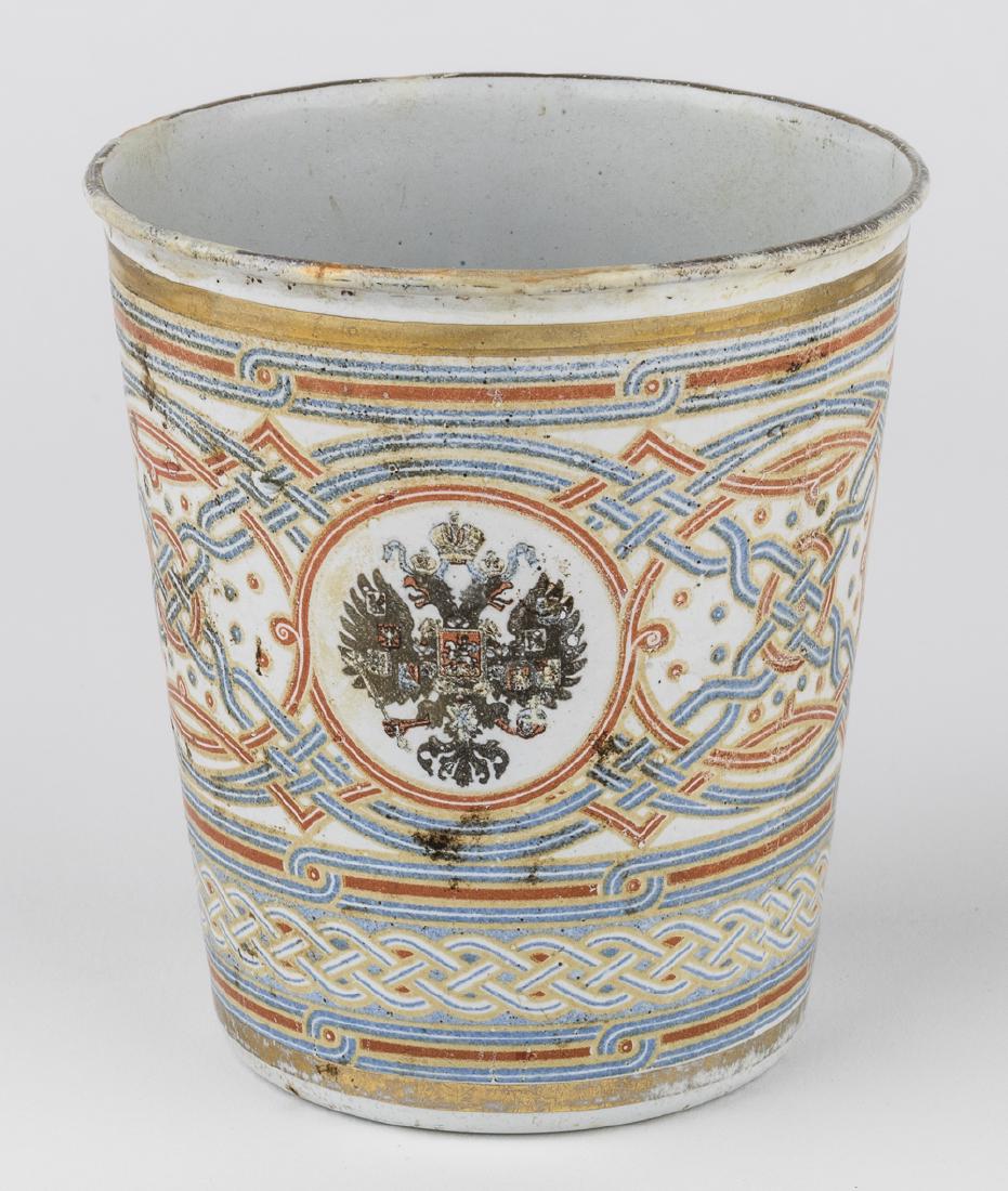 NICHOLAS II "CUP OF SORROWS": Fine relic from the coronation of Russian Tsar Nicholas II, the "Khodynka" cup, or "Cup of Sorrows" made to honor the event. The ceramic-covered copper cup measures 4" tall and 3 1/2" wide at top, bea