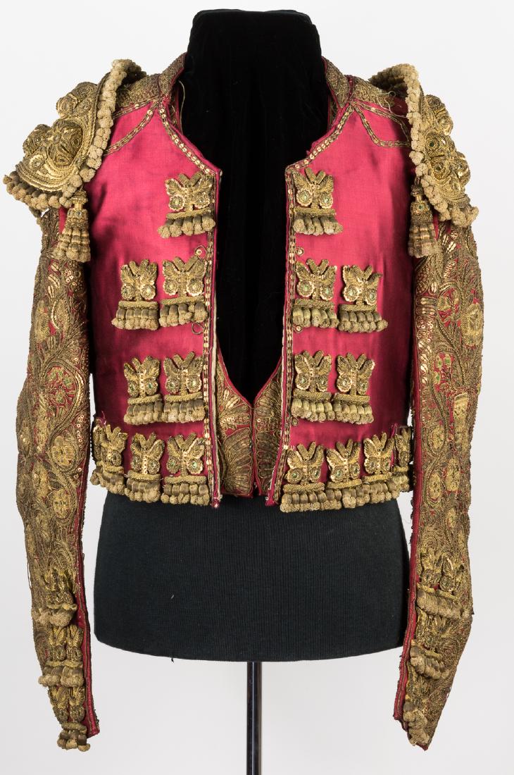 MATADOR'S COSTUME: Excellent late nineteenth or early twentieth-century matador's costume, consisting of vest, short jacket and trousers, all constructed of red silk and lavishly decorated with gold brocade, bullion, ta
