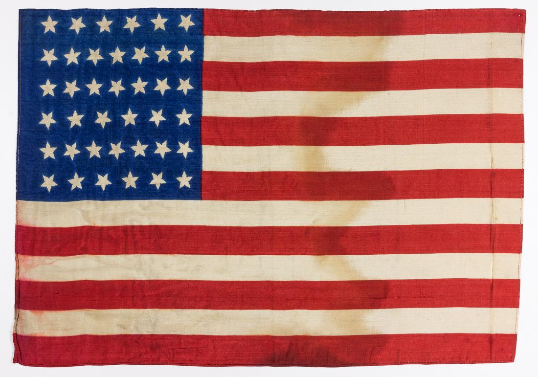 39-STAR POST CIVIL WAR AMERICAN FLAG: Attractive silk 39-star American flag, 17" x 11 3/4", clamp-dyed with colors vivid on both sides, edges hemmed. The right edge of the body of the flag, about 1", was folded for some time, and there is