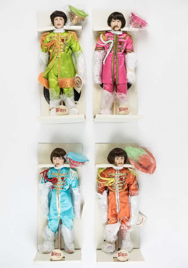 (BEATLES) COMPLETE SET OF BOXED 1986 "STAR SHINE": Rare, complete set of four Star Shine dolls, each representing a different Beatle in his respective Sgt. Pepper band uniform with matching cap. These quality dolls are about 17" tall with metal stands