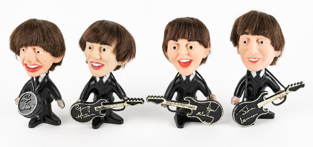 (BEATLES) 1964 BEATLES DOLLS BY SELTAEB INC.: Desirable set of four 4 1/2" tall Beatles dolls made by Nems Seltaeb Inc. (Remco) ca. 1964 with guitars and drum (Ringo). All in excellent condition.
