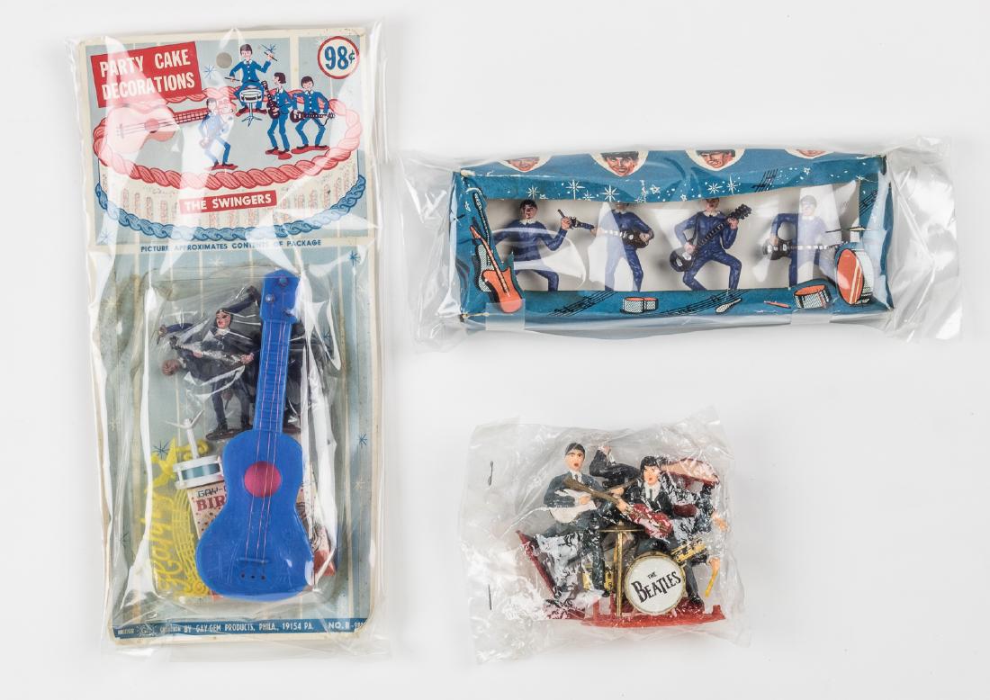 (BEATLES) BEATLES CAKE TOPPERS: Three sets of ca. 1964 unauthorized Beatles cake-toppers, two sets in their original packaging, all unused.