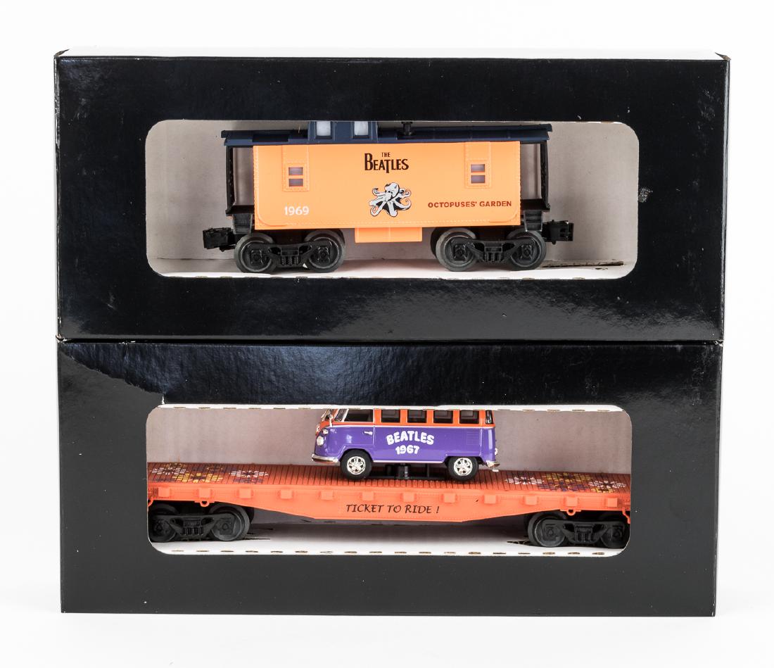 (BEATLES) LIONEL "O" GAUGE BEATLES ROLLING STOCK (2): Pair of custom-painted Beatles commemorative flatcars, Lionel cars likely painted by RGS but in plain black boxes. Included is an orange caboose with an octopus, the title of the song "Octopusesâ€�