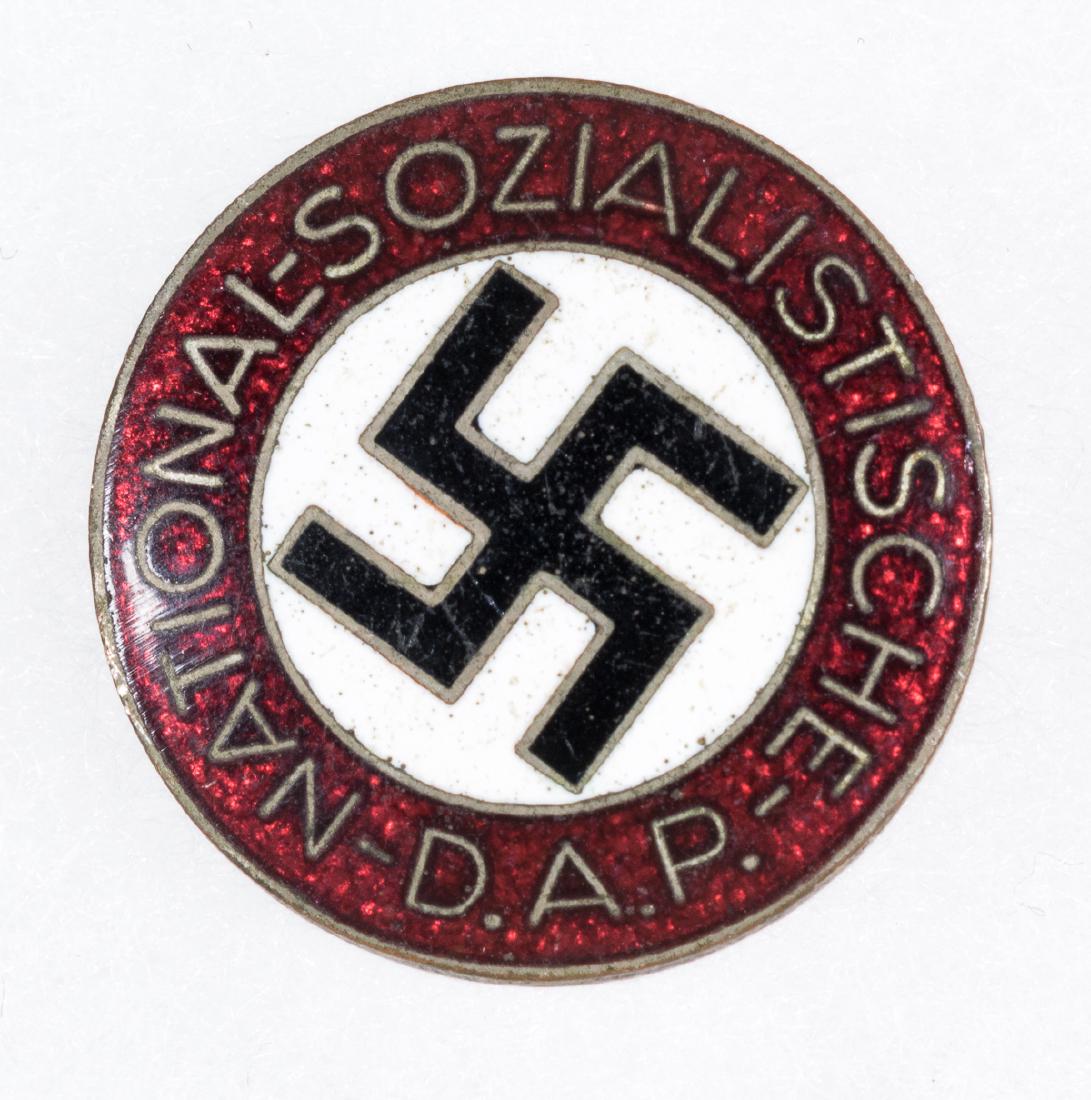 NSDAP MEMBERSHIP BADGE: NSDAP membership badge of enameled tombac, 3/4" dia., marked with the RZM number "M1/42" on the reverse, for maker Kerbach & Israel of Dresden. Shows minor tarnish to the reverse, else very good.