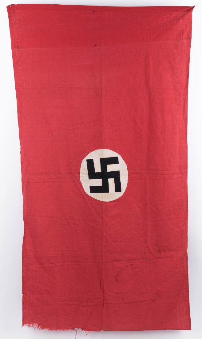 NSDAP FLAG: Early double-sided NSDAP flag, 55 1/2" x 30", of red cotton bunting construction with a white disk clamp-dyed with a mobile swastika sew at center. The hoist end is folded over and sewn, but with no h