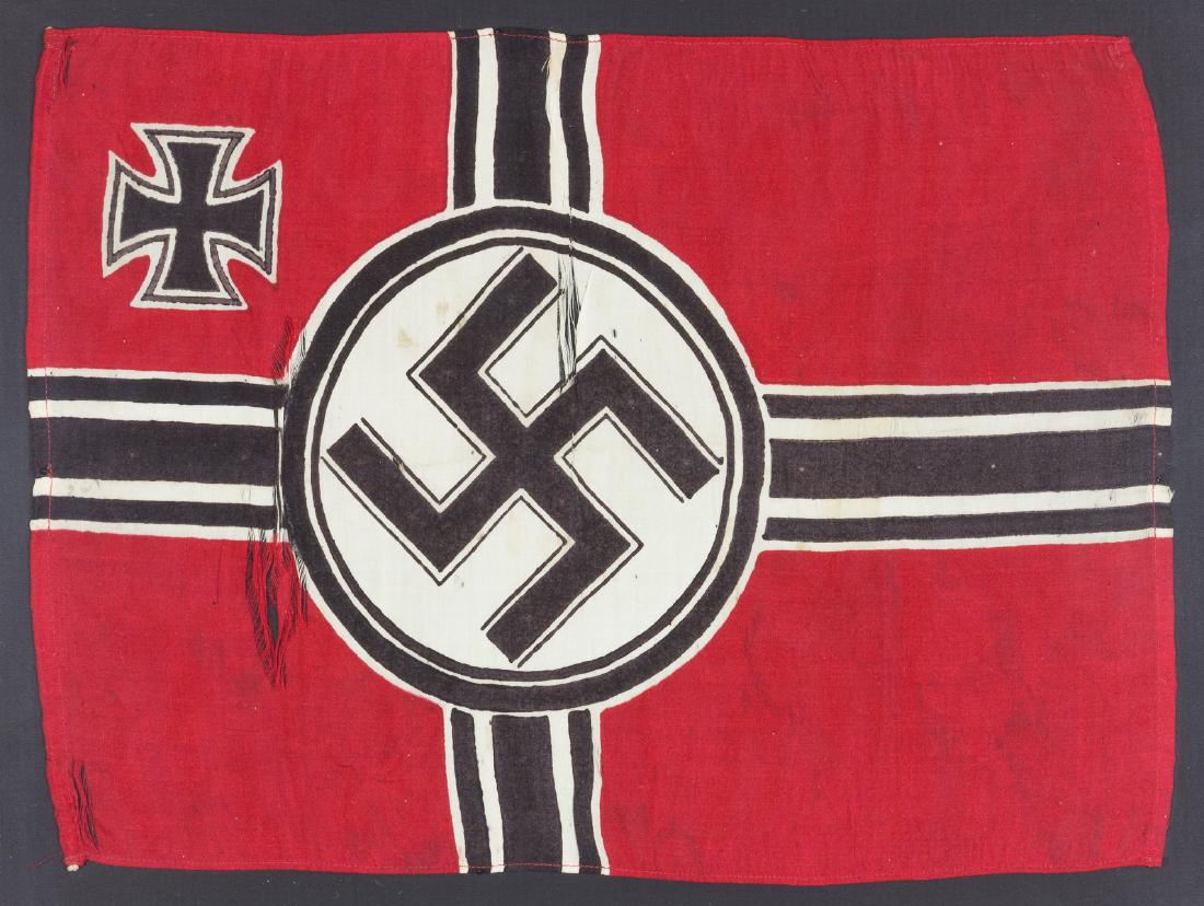 HANDMADE MINIATURE "REICHSKRIEGSFLAGGE": Unusual miniature Third Reich "Reichskriegsflagge"11 1/4" x 8 1/4", with hand-dyed mobile swastika within a white disk intersected by crossed black band, and with an Iron Cross at the upper left canto