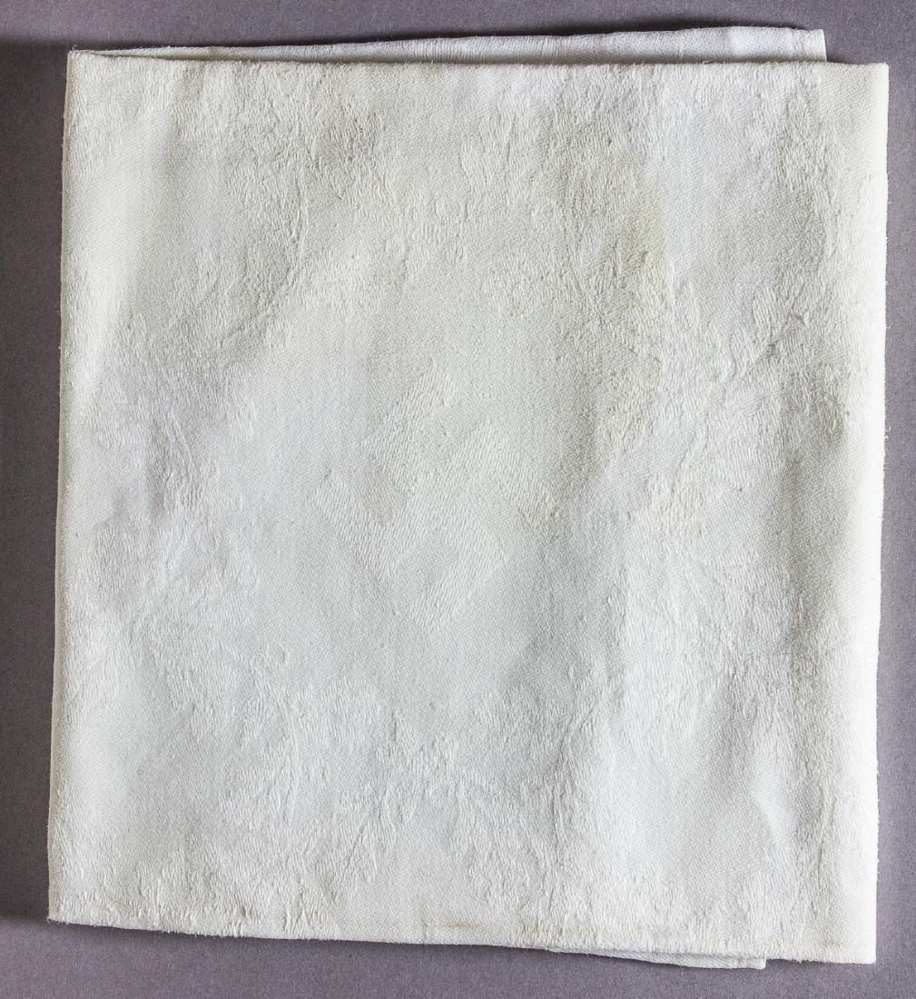 DER DEUTSCHE HOF HOTEL NAPKIN: White linen napkin from the "Der Deutsche Hof" hotel, 22" x 21", with a woven design incorporating a mobile swastika at center, surrounded by a circular wreath and Greek key design. The name of the ho