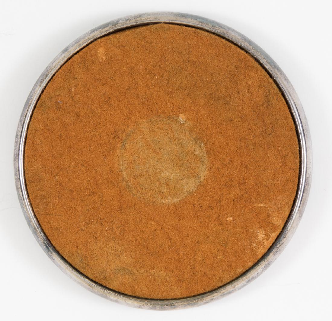 NSDAP SILVER WINE COASTER BY WELLNER: Formal silver-plated wine coaster, 4 1/2" dia., with a fawn felt insert, the base rollmarked with an NSDAP eagle and swastika, and with the manufacturer's name "Wellner" with the silver plate content