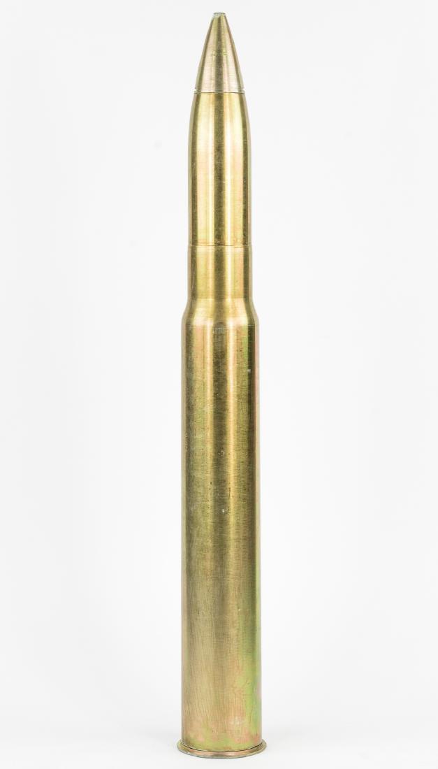 U.S. NAVY 3-INCH GUN DUMMY ROUND: Large practice naval artillery round, 35" x 4 1/4" dia., a one-piece spun brass dummy of a U.S. Navy 3-inch/50 caliber shell. The base is marked: "3In 50 Cal Dummy Cartridge Mk. 8n Mod. 1", with a ser
