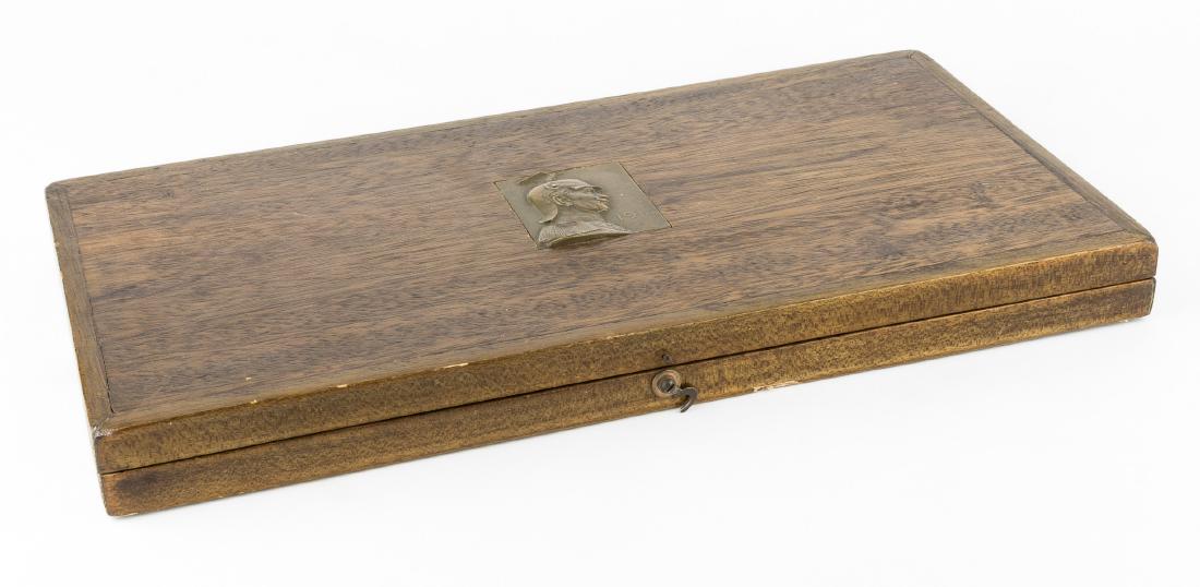 WILHELM II MEDAL PRESENTATION BOX: Finished wood medal presentation box, 16 1/2" x 8 1/4" x 1 1/2", the top lid bearing an inlaid 2 1/4" x 2 1/2" bronze profile portrait of the Kaiser in a Guard de Corps helmet with "1914" date inset t