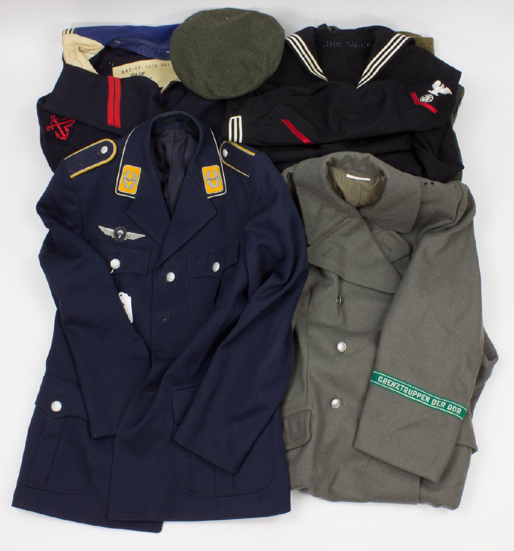 MILITARY UNIFORMS: Large lot of military coats, shirts, and trousers, includes: navy blue West German Air Force uniform jacket, with silver cord paratrooper insignia on the right breast, corded silver wing lapel tabs, a
