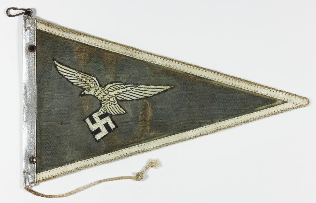LUFTWAFFE OFFICER'S AUTOMOBILE PENNANT: Luftwaffe "dienstwimpel" ("service pennant"), 12 3/4" x 7 3/4", intended to be displayed on an automobile when occupied by an officer. The pennant is constructed of blue-grey cloth-covered card stock,