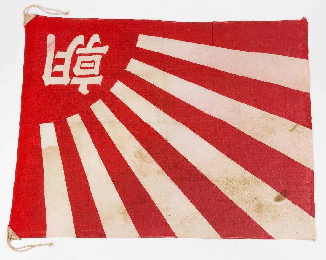 ASAHI SHIMBUN JAPANESE FLAG: World War II-era cotton flag, 34 ½" x 26 ½", the flag of the Japanese newspaper "Asahi Shimbun", clamp-dyed with a one-quarter rising sun, with the Kanji "Asahi". The flag is fitted with