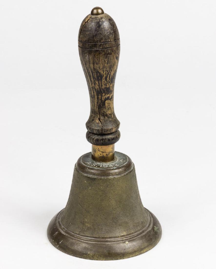 BRITISH AMBULANCE SERVICE BELL: Bronze bell, approx. 3 1/2" x 5" dia., with a 6 3/4" wood handle, marked "A.S. 1942" at the top of the bell, along with the "Broad Arrow" mark, indicative of British government property. Bells of this