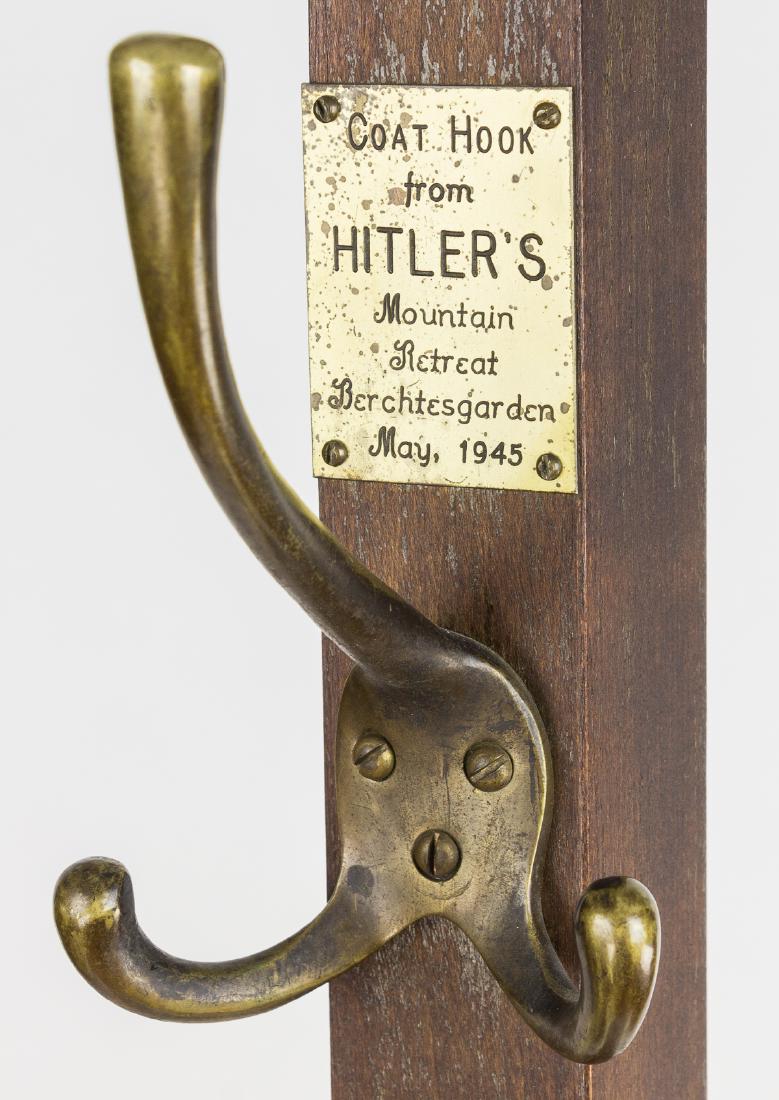 COAT HOOK FROM ADOLF HITLER'S BERGHOF: A most unusual Adolf Hitler relic, a wood coat and hat rack, 69" tall, bearing a coat hook retrieved from the Berghof, Adolf Hitler's mountain retreat at Obersalzberg. The rack is fitted with four bra