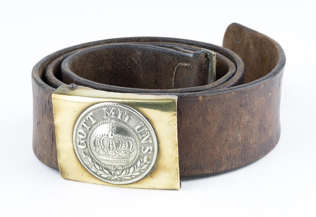 IMPERIAL GERMAN ARMY BELT AND BUCKLE: Brown leather belt, 41" x 1 1/2", of the type worn universally by enlisted men of the Imperial German Army during World War I. The belt is stamped "GR6 1889" at the tongue (possibly giving a date of m