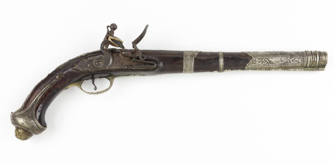 TURKISH SILVER-MOUNTED FLINTLOCK PISTOL: Late 17th- or early 18th-century Turkish or Middle Eastern flintlock pistol, 12 1/4" barrel, 18 1/2" overall, heavily decorated with silver mountings depicting geometric, figural and foliate motifs at