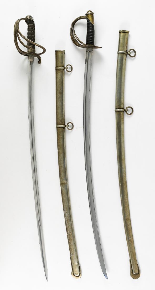 CAVALRY-STYLE SABERS: Pair of nineteenth or early twentieth-century sabers, the first 33" blade, 39" overall, with a three-bar basket-style hilt, peened to the blade tang and securing a wood grip covered with browned raysk