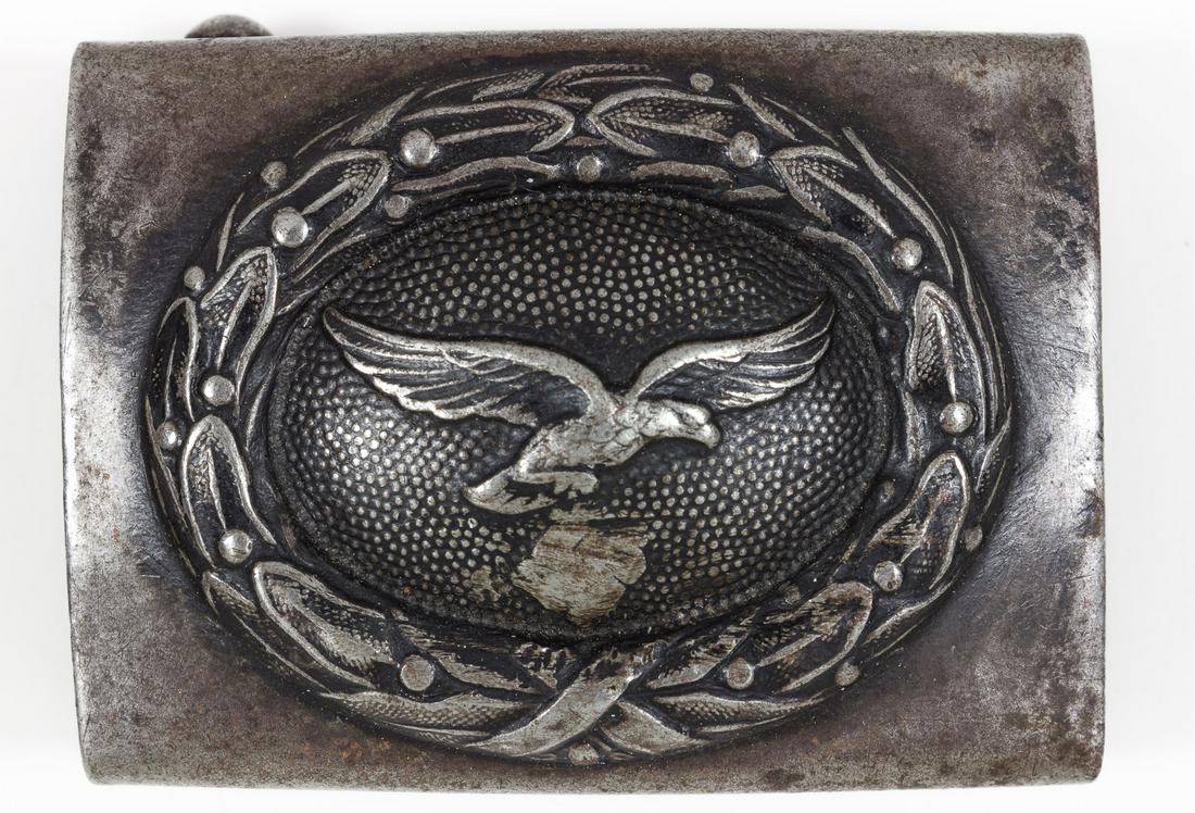 DE-NAZIFIED LUFTWAFFE BELT BUCKLE: Steel box-style belt buckle, 2 1/2' x 1 3/4', bearing a wrathed Luftwaffe eagle with the swastika ground off, indicating postwar 'de-nazification'. The buckle is unmarked and shows a dark patina overa